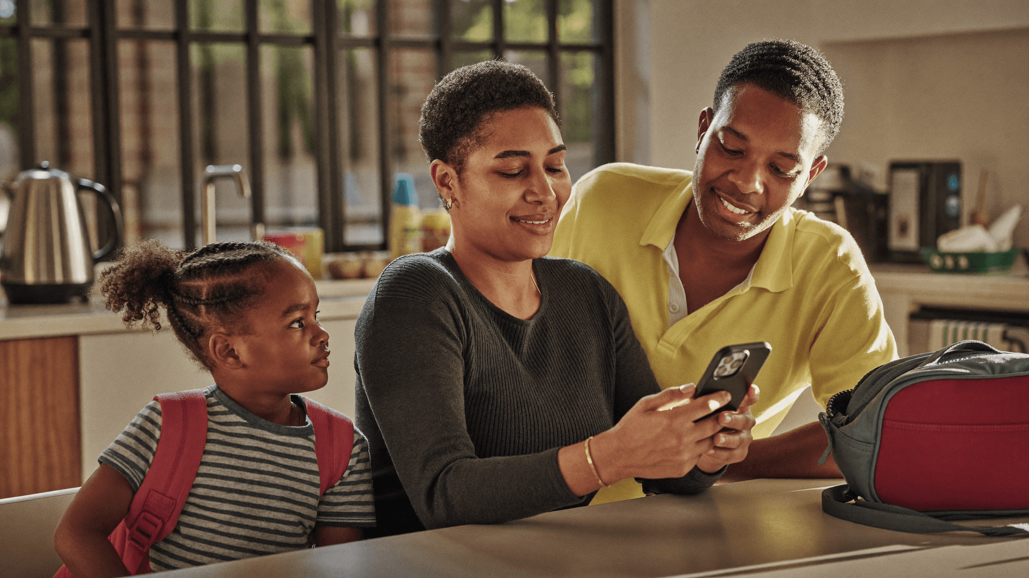 South African family calmly testing a phone safety app at the kitchen table